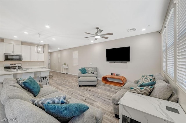 living room featuring recessed lighting, visible vents, ceiling fan, and light wood finished floors