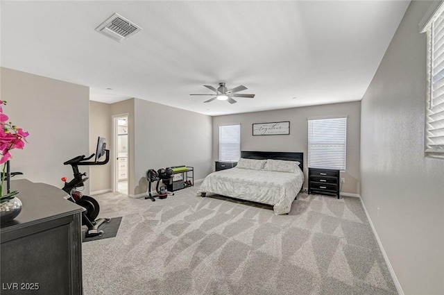 bedroom featuring visible vents, carpet flooring, ensuite bathroom, and baseboards