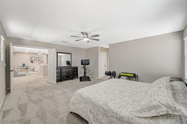 carpeted bedroom with visible vents, baseboards, and a ceiling fan