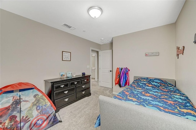 carpeted bedroom featuring visible vents