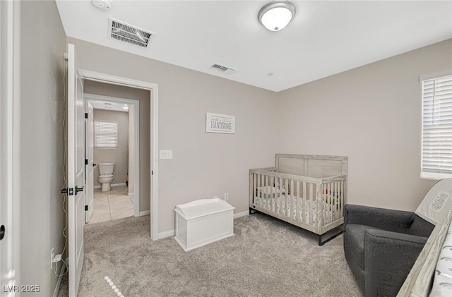 carpeted bedroom featuring visible vents, multiple windows, and baseboards