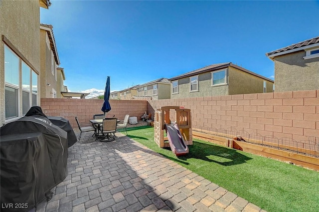 view of patio with area for grilling and a fenced backyard