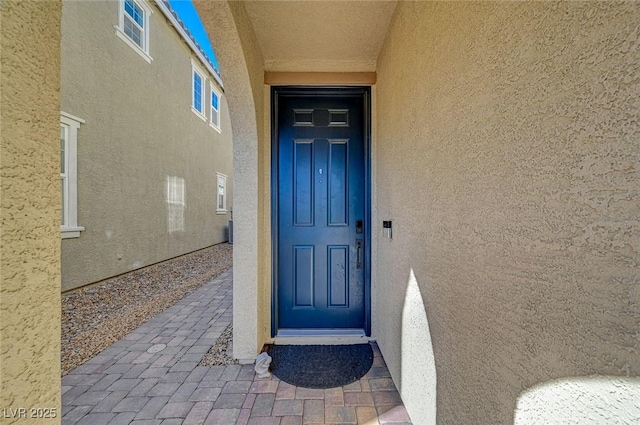 entrance to property with stucco siding