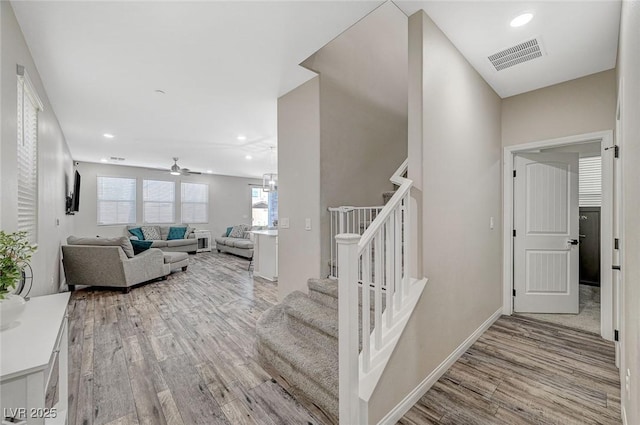 staircase with recessed lighting, wood finished floors, visible vents, and ceiling fan