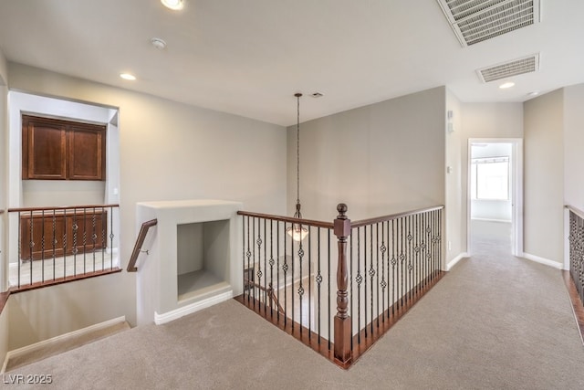 corridor featuring carpet, baseboards, and recessed lighting