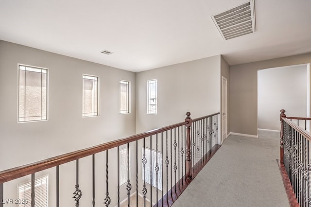 hall with carpet flooring and baseboards