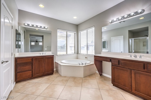 bathroom with a stall shower, two vanities, tile patterned flooring, and a bath