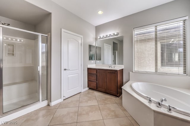 full bath with a bath, tile patterned floors, a shower stall, vanity, and healthy amount of natural light
