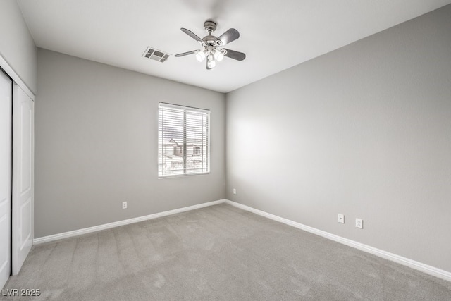 unfurnished bedroom with a closet, carpet, baseboards, and ceiling fan