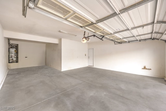 garage featuring water heater and a garage door opener