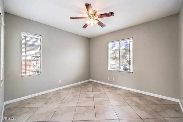 unfurnished room featuring light tile patterned floors, a ceiling fan, and baseboards