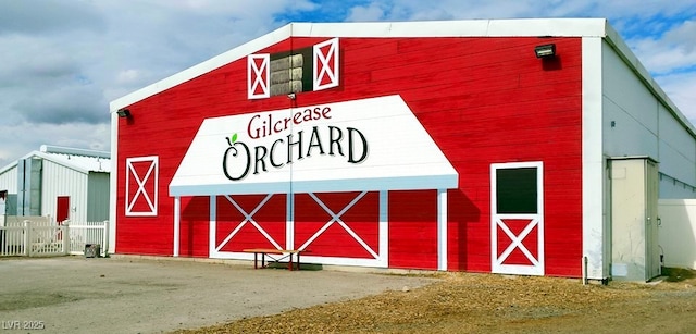 view of barn with fence
