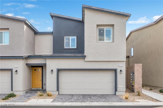 4125 Venus Falls Ave, North Las Vegas, NV 89084 - townhome / multi-family property with an attached garage, stucco siding, and decorative driveway