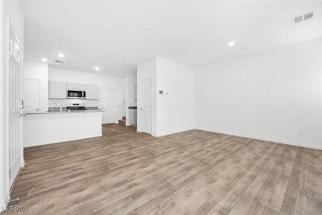 4125 Venus Falls Ave, North Las Vegas, NV 89084 - unfurnished living room with light wood-type flooring and recessed lighting