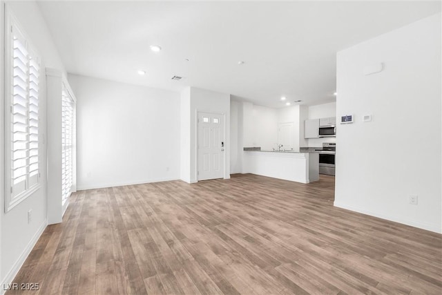4125 Venus Falls Ave, North Las Vegas, NV 89084 - unfurnished living room with wood finished floors and recessed lighting