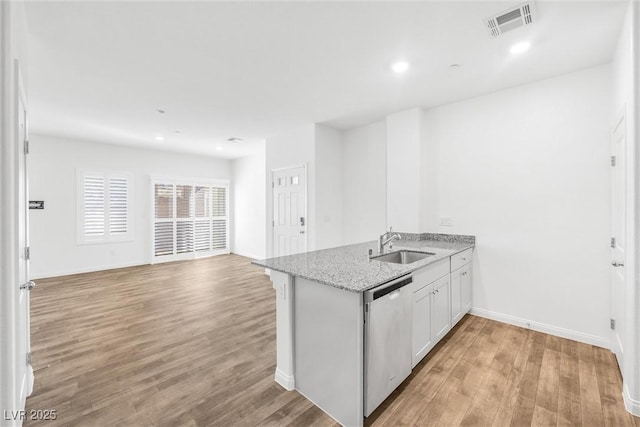 4125 Venus Falls Ave, North Las Vegas, NV 89084 - kitchen featuring stainless steel dishwasher, light wood-type flooring, a peninsula, light stone countertops, and recessed lighting