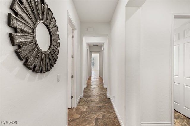 50 Carolina Cherry Dr, Las Vegas, NV 89141 - hallway featuring baseboards and stone tile floors