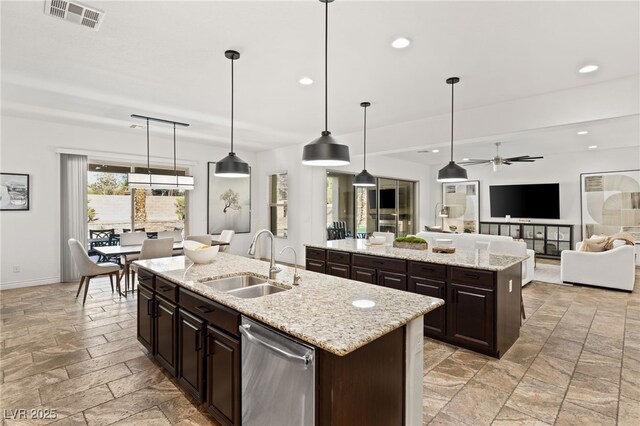 50 Carolina Cherry Dr, Las Vegas, NV 89141 - kitchen with an island with sink, dishwasher, stone tile floors, ceiling fan, and recessed lighting
