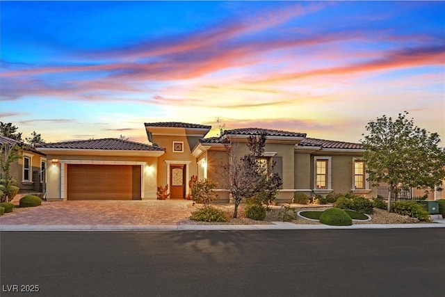 50 Carolina Cherry Dr, Las Vegas, NV 89141 - view of front facade featuring a garage, driveway, stucco siding, and a tiled roof