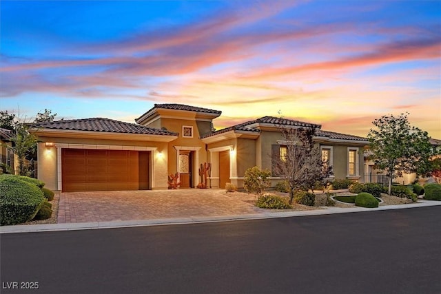 50 Carolina Cherry Dr, Las Vegas, NV 89141 - mediterranean / spanish home featuring a garage, driveway, stucco siding, and a tile roof