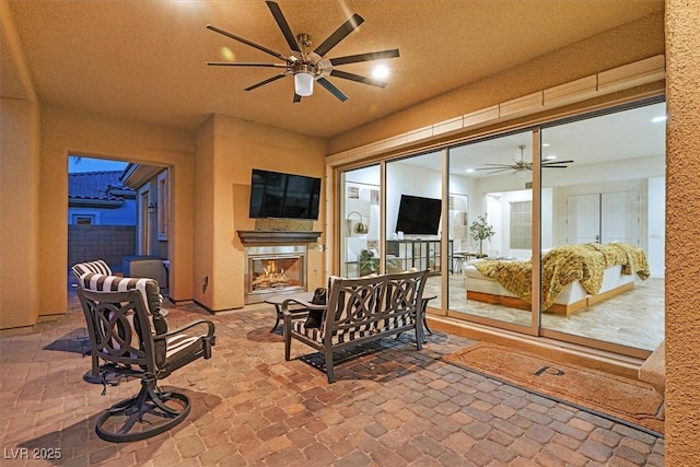 50 Carolina Cherry Dr, Las Vegas, NV 89141 - view of patio / terrace featuring a glass covered fireplace and a ceiling fan