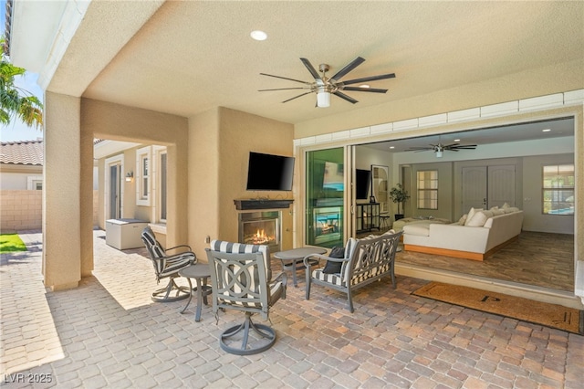 50 Carolina Cherry Dr, Las Vegas, NV 89141 - view of patio with ceiling fan and an outdoor living space with a fireplace