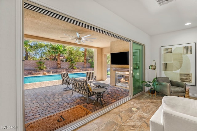 50 Carolina Cherry Dr, Las Vegas, NV 89141 - view of patio with a glass covered fireplace and ceiling fan