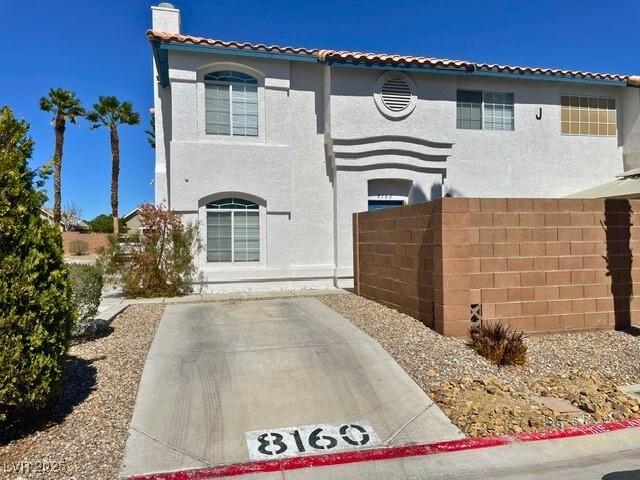 8160 Autumn Star Ave, Las Vegas, NV 89145 - mediterranean / spanish home with fence, a chimney, a patio area, and stucco siding