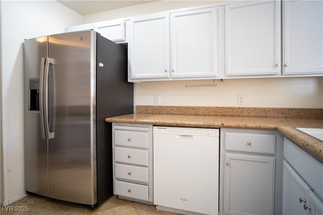 8160 Autumn Star Ave, Las Vegas, NV 89145 - kitchen featuring light tile patterned flooring, stainless steel fridge, light countertops, white cabinets, and dishwasher