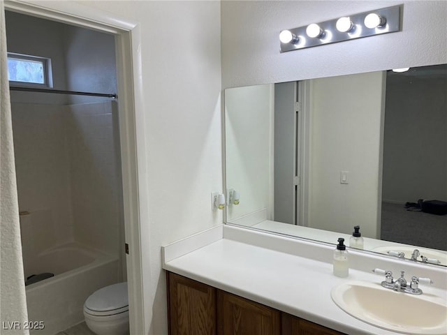 bathroom featuring washtub / shower combination, toilet, and vanity