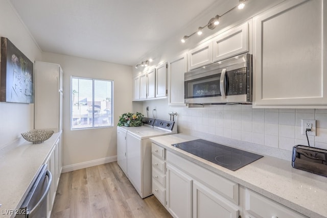 725 N Royal Crest Cir Unit 227, Las Vegas, NV 89169 - kitchen featuring appliances with stainless steel finishes, washing machine and clothes dryer, decorative backsplash, white cabinets, and light wood finished floors