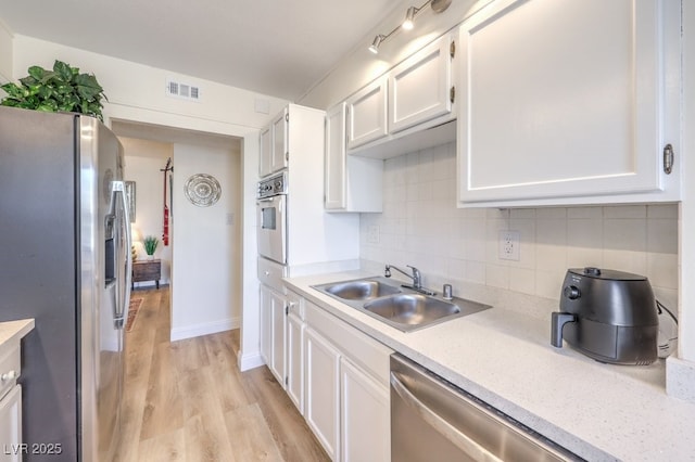 725 N Royal Crest Cir Unit 227, Las Vegas, NV 89169 - kitchen featuring stainless steel appliances, a sink, light countertops, light wood-style flooring, and white cabinetry