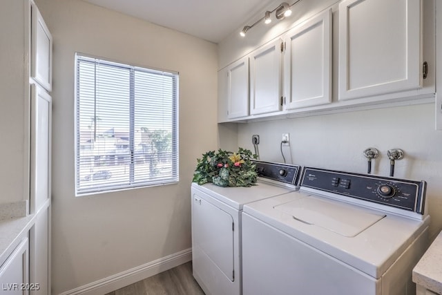 725 N Royal Crest Cir Unit 227, Las Vegas, NV 89169 - washroom featuring washer and clothes dryer, cabinet space, wood finished floors, and baseboards
