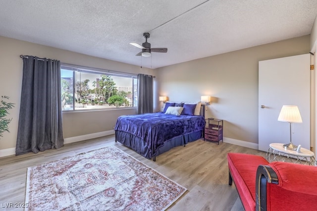 725 N Royal Crest Cir Unit 227, Las Vegas, NV 89169 - bedroom with a textured ceiling, baseboards, wood finished floors, and ceiling fan