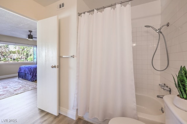 725 N Royal Crest Cir Unit 227, Las Vegas, NV 89169 - bathroom featuring toilet, wood finished floors, shower / bath combination with curtain, and baseboards