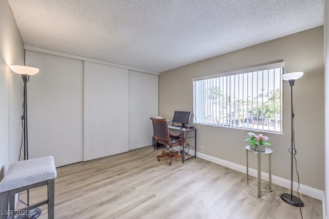 725 N Royal Crest Cir Unit 227, Las Vegas, NV 89169 - home office featuring wood finished floors, a textured ceiling, and baseboards