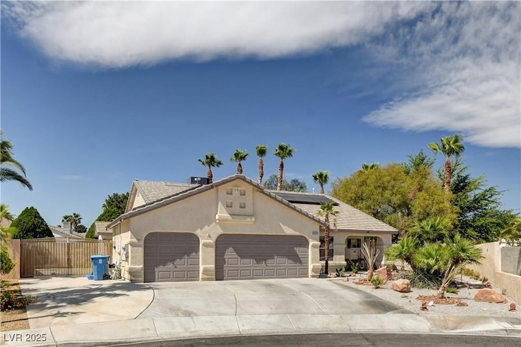 6513 Echo Crest Ave, Las Vegas, NV 89130 - view of front facade with concrete driveway, stucco siding, fence, an attached garage, and solar panels