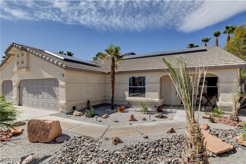 6513 Echo Crest Ave, Las Vegas, NV 89130 - ranch-style home featuring roof mounted solar panels, stucco siding, a garage, and concrete driveway
