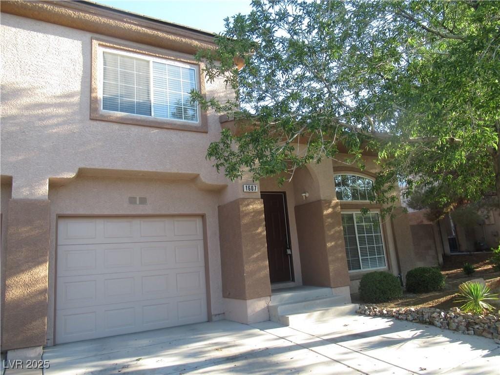 1607 Colloquium Dr Unit 0, Henderson, NV 89014 - view of front of house featuring concrete driveway, an attached garage, and stucco siding