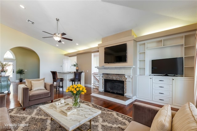 380 Claremont St, Boulder City, NV 89005 - living area with vaulted ceiling, visible vents, a ceiling fan, arched walkways, and a glass covered fireplace