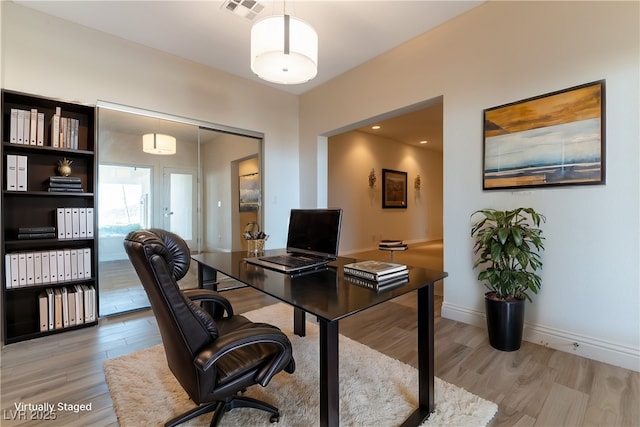 380 Claremont St, Boulder City, NV 89005 - home office with visible vents, light wood finished floors, and baseboards