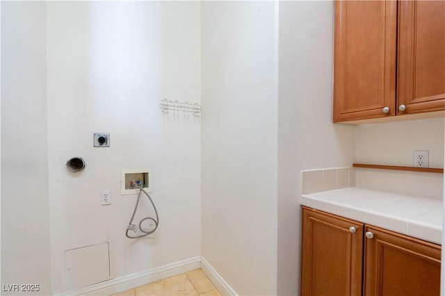 26 Via Vasari Unit 204, Henderson, NV 89011 - washroom featuring hookup for an electric dryer, hookup for a washing machine, cabinet space, and light tile patterned flooring