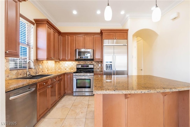 26 Via Vasari Unit 204, Henderson, NV 89011 - kitchen with stainless steel appliances, light stone counters, ornamental molding, decorative backsplash, and arched walkways