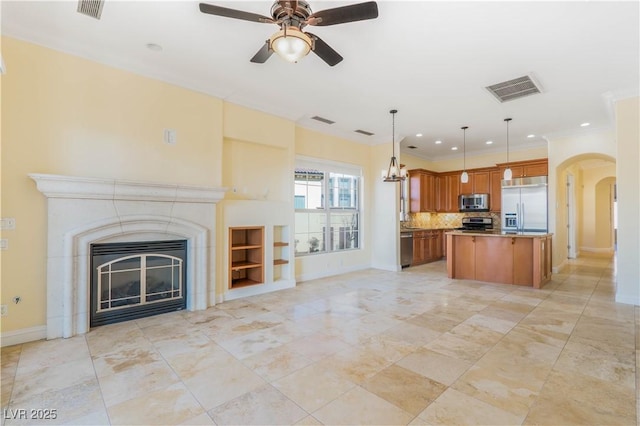 26 Via Vasari Unit 204, Henderson, NV 89011 - unfurnished living room featuring arched walkways, recessed lighting, built in features, a ceiling fan, and a glass covered fireplace