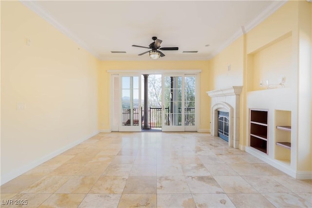 26 Via Vasari Unit 204, Henderson, NV 89011 - unfurnished living room with a ceiling fan, crown molding, built in shelves, and a glass covered fireplace