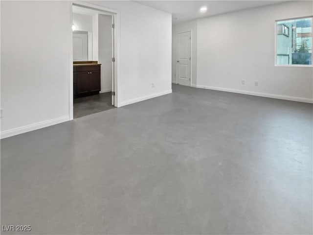 10537 Headwind Ave, Las Vegas, NV 89129 - unfurnished room with concrete floors, baseboards, and recessed lighting
