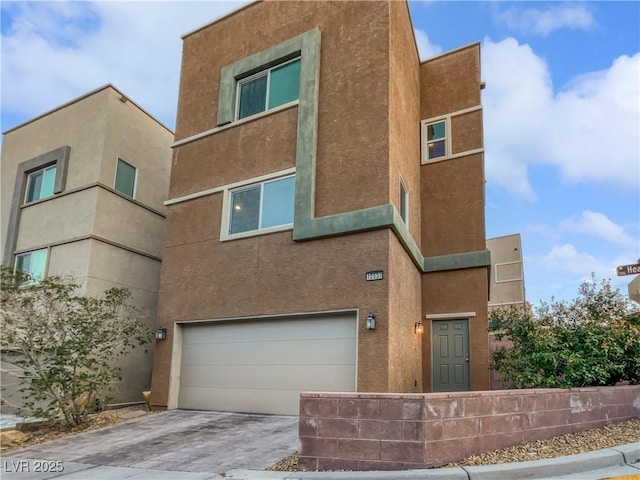 10537 Headwind Ave, Las Vegas, NV 89129 - view of front of home featuring stucco siding, driveway, and a garage