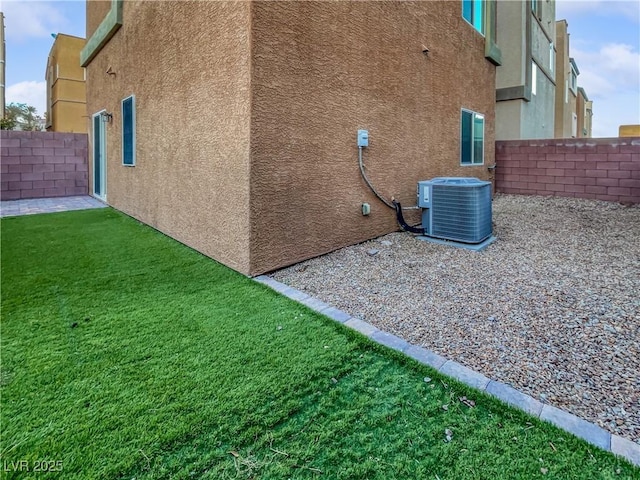 10537 Headwind Ave, Las Vegas, NV 89129 - view of side of home with cooling unit and stucco siding