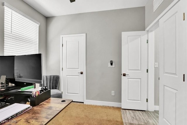 bedroom with light wood-type flooring and baseboards