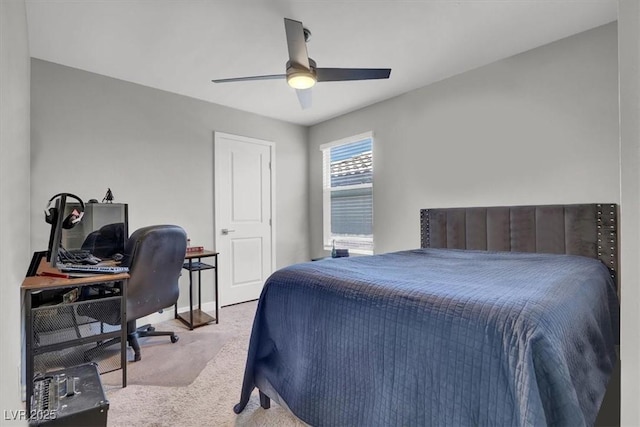 carpeted bedroom with ceiling fan and baseboards